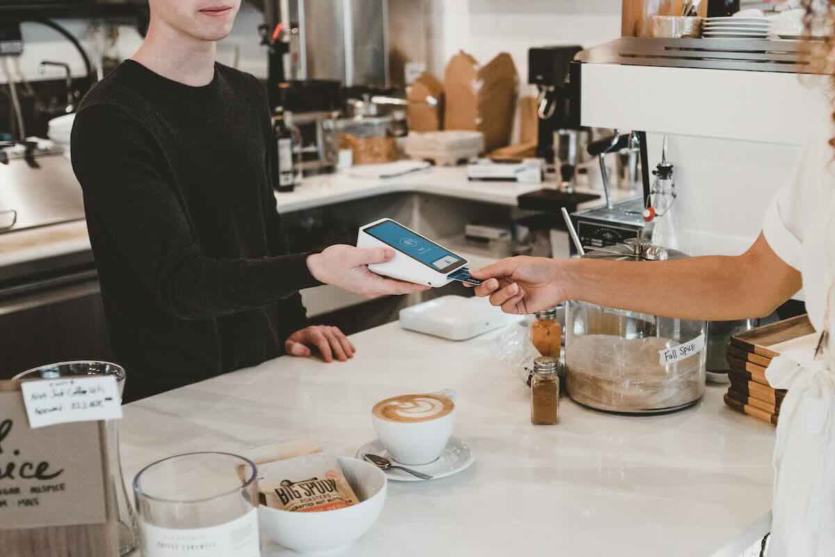 Customer paying with a credit card at a small business checkout counter